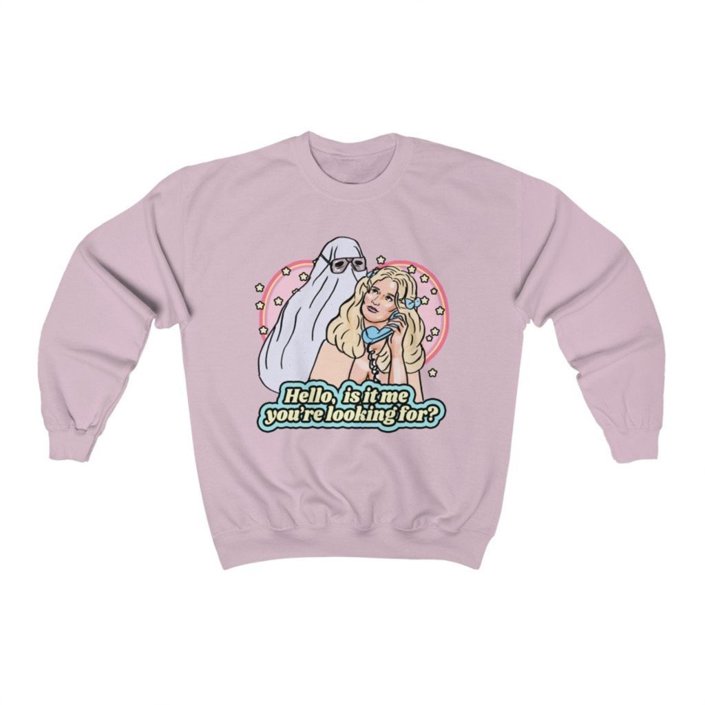 Product photo of pastel pink crew neck sweatshirt with retro illustration of Lynda (P.J. Soles) on the phone with Michael Myers sneaking up behind her from Halloween (1978)