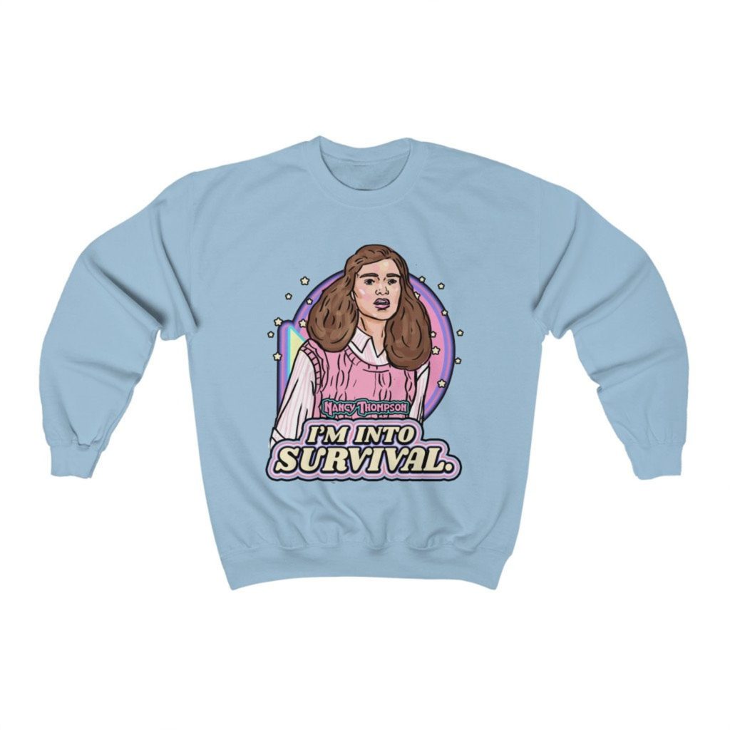 Product photo of pastel blue crew neck sweatshirt with retro illustration of Nancy Thompson (Heather Langenkamp) from A Nightmare on Elm Street (1984) with movie quote below