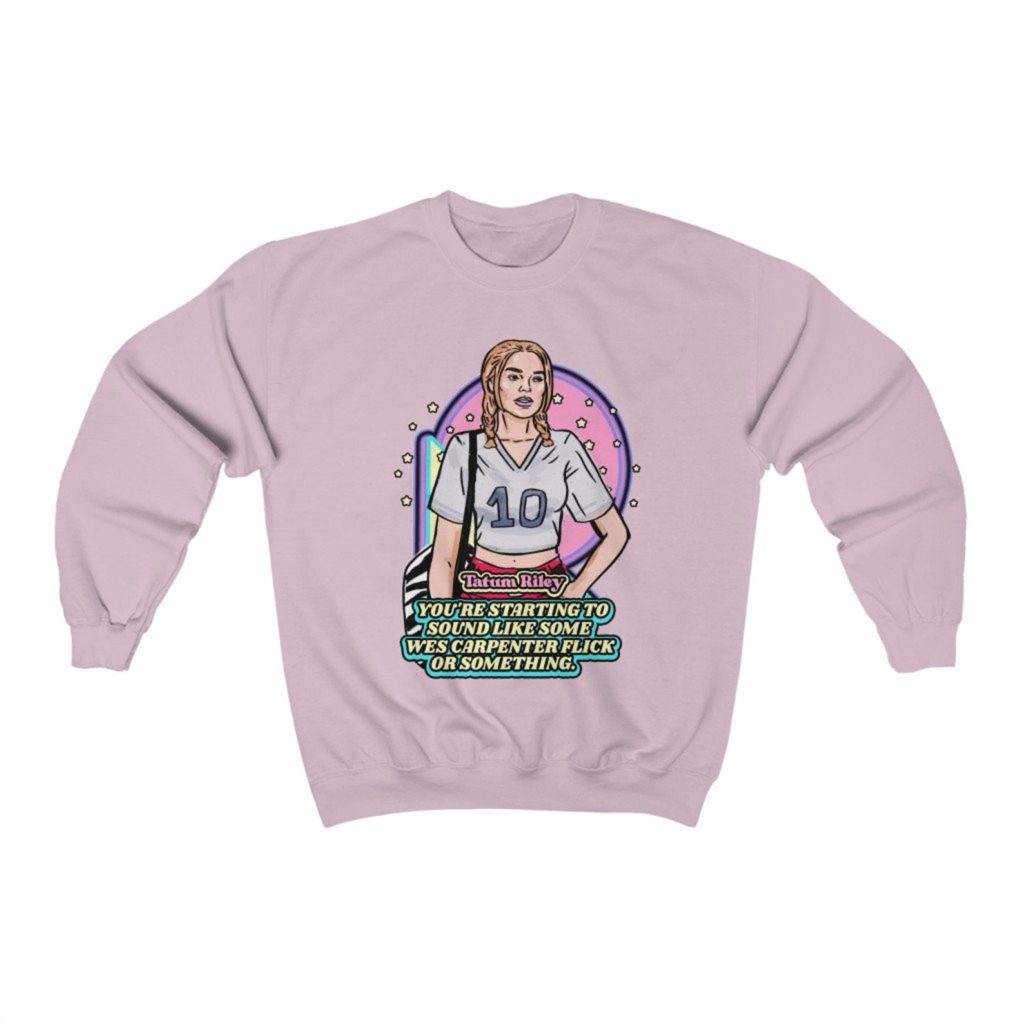 Product photo of pastel pink crew neck sweatshirt with retro illustration of Tatum Riley (Rose McGowan) from Scream (1996) with movie quote below